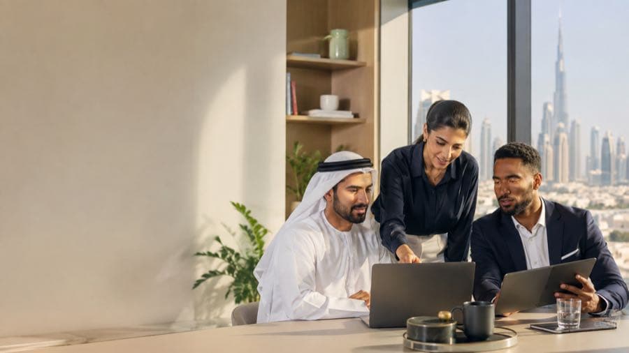 Dubai business strategy team reviewing a conversational advertising campaign on laptops